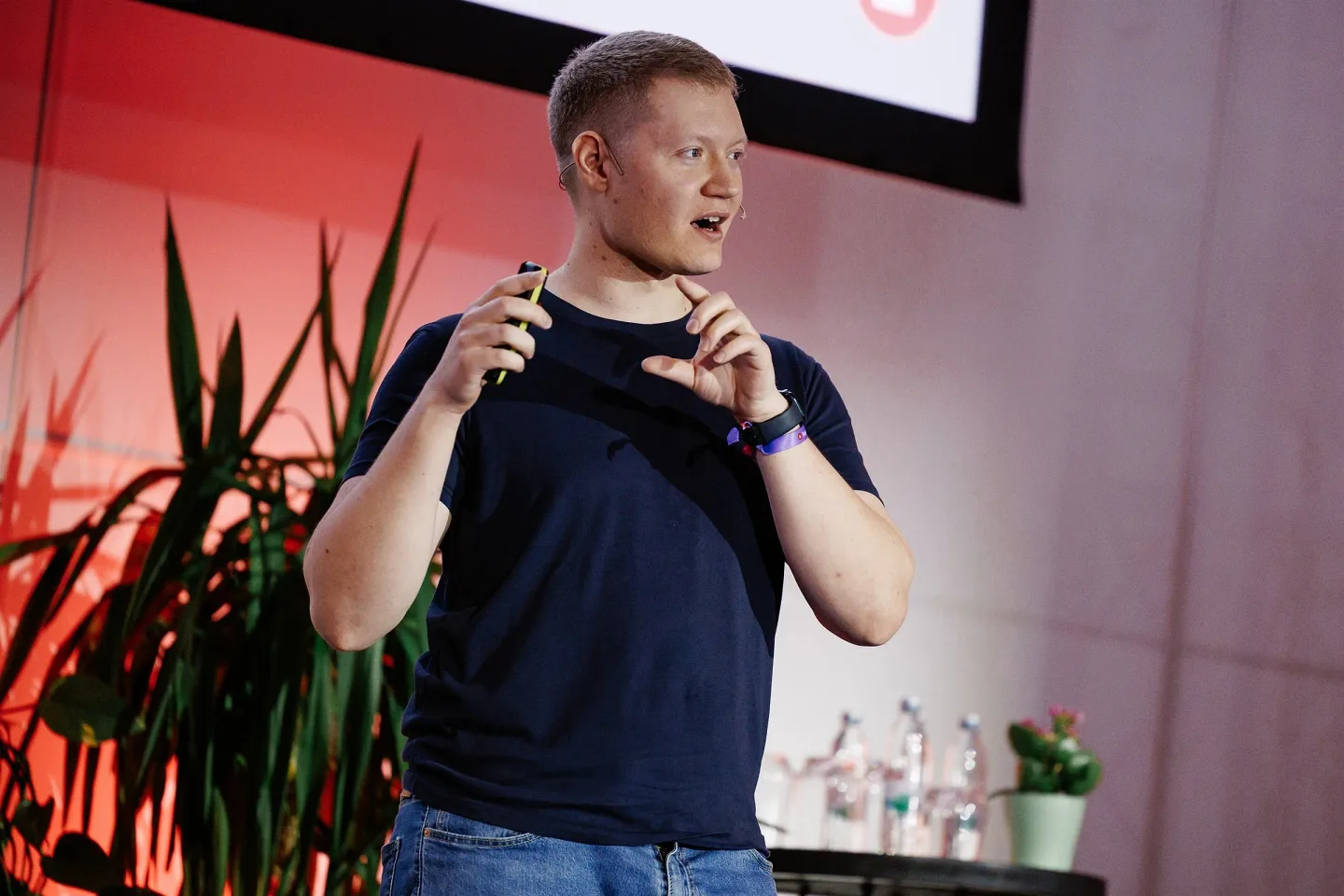 Aleksander Cardwell speaking on stage